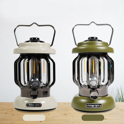 Two vintage-style camping LED lanterns with metal handles and ABS lampshades in beige and green colors on a wooden surface